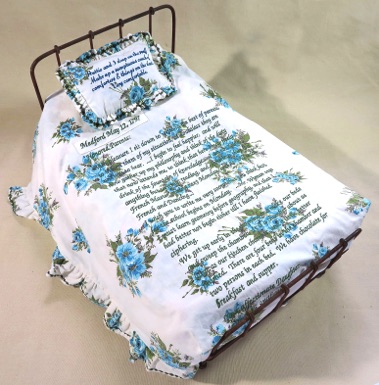 Unique artist bed book work, antique metal doll bed, embroidered text, vintage textiles
