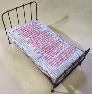 Unique artist book bed, Vintage metal doll bed, embroidered stories text girls in institutions, schools, vintage and recycled textiles